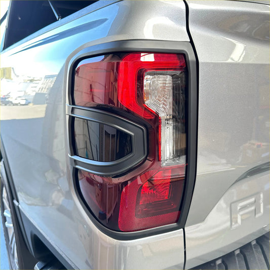The back side of a ford ranger 2022 taillight cover with sleek red and clear lenses in a black plastic bezel