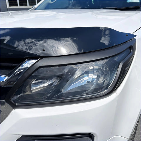 Black glossy hood deflector with sleek aerodynamic design mounted on white holden colorado 2016-2020 matte