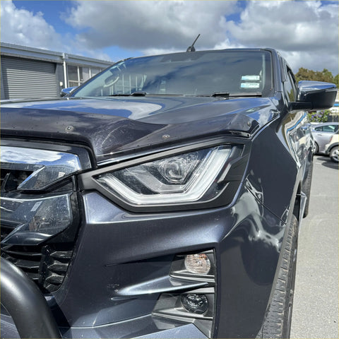 Dark gray metallic isuzu d-max with sleek led headlight covers and rugged front grille for 2021-2023 models