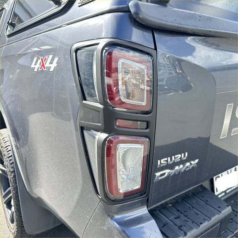 Rear view of dark gray isuzu d-max 2021-2023 with modern rectangular led taillight covers in black plastic bezels