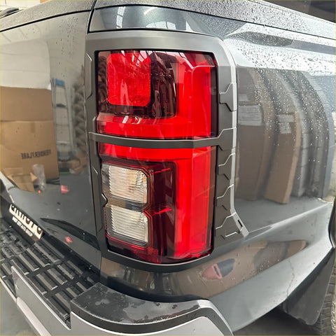 Black truck taillight cover with red and clear lenses in matte rugged gray plastic bezel for mitsubishi triton 2024+
