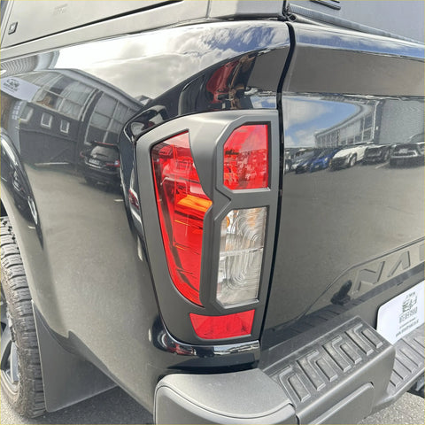 Back side of black nissan navara 2021+ sl matte taillight cover with red and clear lens sections