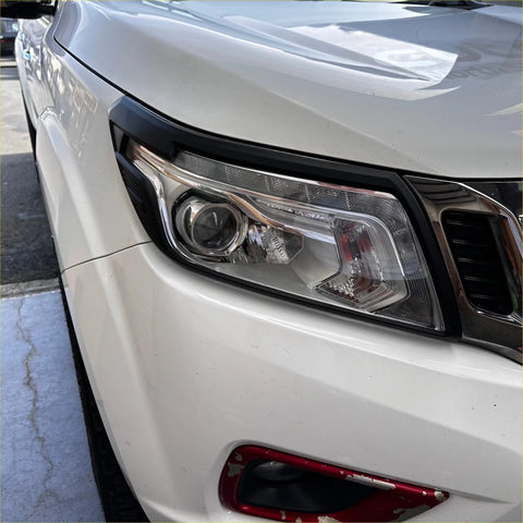 The headlight cover for white nissan navara np300 2015-2020 features a sleek design with clear lenses and chrome accents