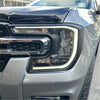 Headlight covers for ford ranger 2022+ in matte black showing a modern gray pickup with chrome and led daytime running light