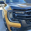 Front headlight of gold and black ford ranger 2022 with matte black led headlight covers and chrome accents