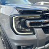 Gray metallic ford f-150 headlight with chrome accents and led lighting featured in matte black ford ranger 2022 headlight covers