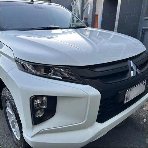 Matte black headlight covers for white mitsubishi triton 2019-2023 with glossy finish and black front grille