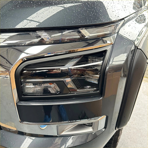 Matte black headlight covers for mitsubishi triton 2024 plus on sleek dark gray suv with sharp chrome accents