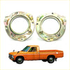 Shiny metallic circular engine mount brackets for vintage orange pickup truck on the backside