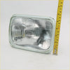 Rectangular chrome finished headlight with clear ribbed lens and embossed hella logo for Toyota Hilux 1979-1983