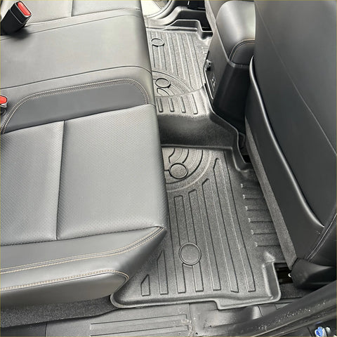 Black rubber heavy duty mat for isuzu d-max 2024+ with molded ridges and circular cutouts for vehicle footwell
