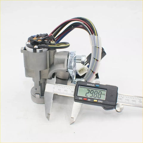 Gray metallic ignition door fuel lid lock set for mazda b series bravo b2200 with multi-colored wiring and digital caliper measuring 29 mm
