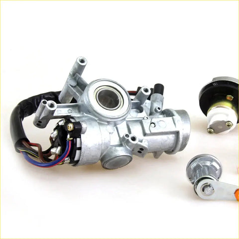 Silver metal ignition door and fuel tank lock assembly for toyota hilux 1983-1988 with visible wiring and parts
