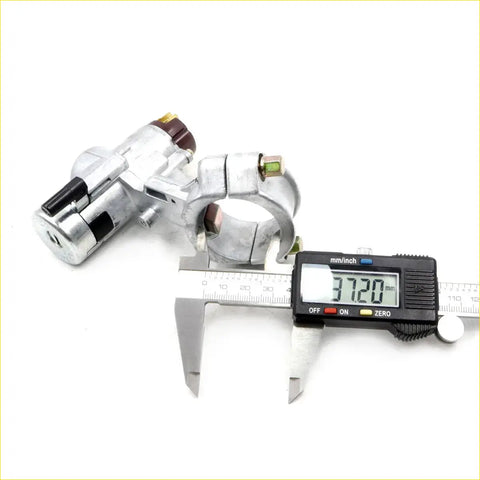 Silver metal ignition switch lock with black plastic keyhole cover and brass accents for nissan pulsar n13 sedan 86-90