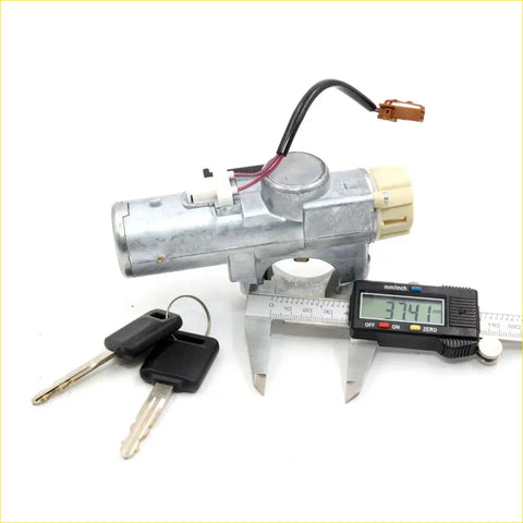 Silver metallic ignition switch with beige plastic housing and wiring with two black key fobs for nissan terrano regulus infiniti qx4 1999-2001
