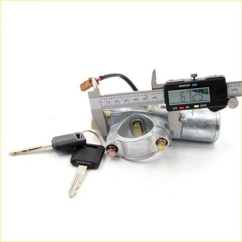 Silver metal ignition switch with black keys and steering lock for nissan maxima a33b gxe se shown with caliper measurement