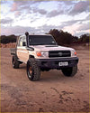Cream-colored toyota land cruiser 70 pickup with rugged kenda klever mt2 33x12.5 r20 off-road tires and black bumper