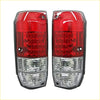 Led tail lights pair with red and clear textured lenses mounted on black plastic housings back side shown