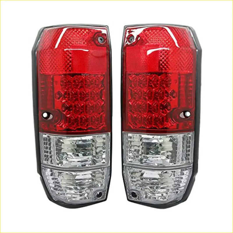 Led tail lights pair with red and clear textured lenses mounted on black plastic housings back side shown