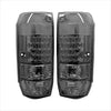 Pair of black smoked led tail lights with textured lens and multiple light segments for vehicles