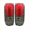 Led tail lights pair with red and clear textured lenses featuring brake and reverse light sections