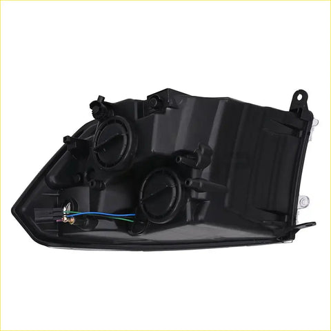 Black plastic left chrome headlamp housing with wiring and mounts for dodge ram 2009 to 2018 shown from back side
