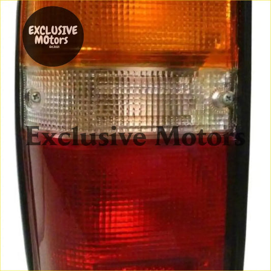 Left hand tail light for toyota hilux 1984-1988 with orange red dual tone textured grid lens shown from back side
