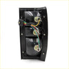 Backside of black plastic lh tail light assembly for mitsubishi l200 double cab with three circular bulb housings and wires