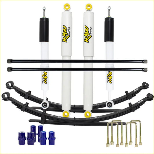 Set of four white and black raw nitro shock absorbers with yellow accents and black leaf springs for mazda lift kit
