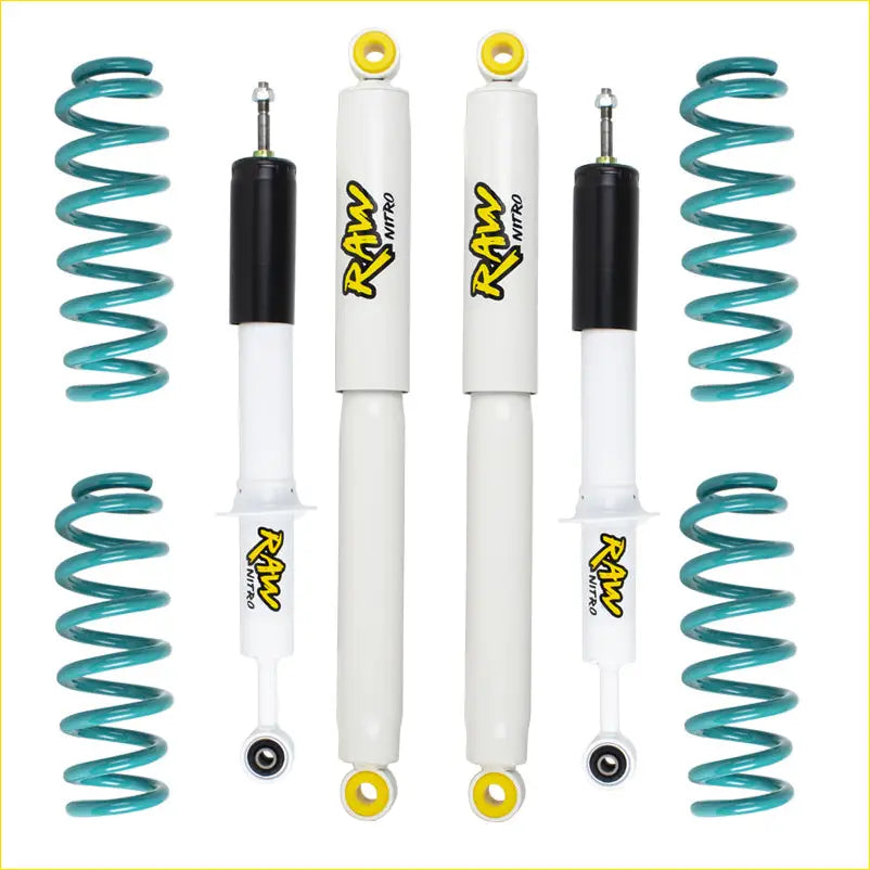 Set of four white and black raw nitro shock absorbers with yellow accents and teal springs for toyota landcruiser 105 lift kit
