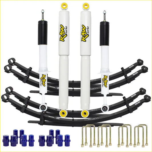 White and black raw nitro shock absorbers with yellow accents and black leaf springs in lift junkie 2 suspension lift kit for toyota landcruiser 75 series