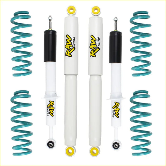 Set of four white and black raw nitro shock absorbers with yellow accents and teal springs for toyota landcruiser 80 series lift kit