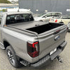 Gray ford ranger pickup truck with black manual roller shutter tonneau cover on the back for 2022+ new ranger