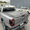 Gray manual roller shutter retractable tonneau cover on the back of a ford ranger 2022+ pickup truck