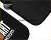 Black textured Mitsubishi Ralliart custom print floor mat with bold white art motors logo and orange accent stripe