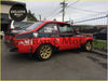 Red and black rally race car showing the back side of mk2 rear tarmac alloy flare single with gold rims