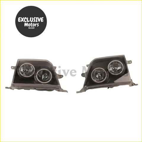 Modified black dual-headlight assemblies with circular lenses and metallic trim for toyota land cruiser prado 1998-1999