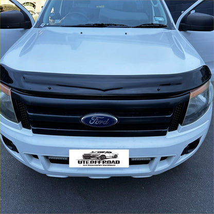 Black plastic monsoon bonnet guard with glossy finish fitted on front of white ford ranger px1 2012-2015 pickup truck