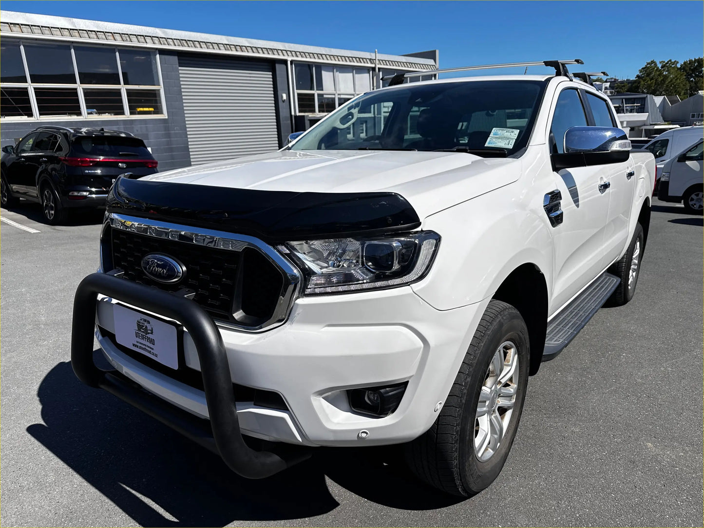 White ford ranger pickup with black monsoon and bonnet guard aftermarket style px2 px3 and chrome accents