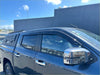 Dark blue metallic mitsubishi triton 2024 with black tonneau cover and chrome mirrors featuring monsoon and bonnet guard