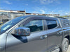 Gray metallic chevrolet silverado pickup with chrome side mirrors and black roof rack showing monsoon bonnet guard