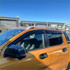 Orange ford ranger 2022 pickup with black window visors and silver roof rack featuring monsoon and bonnet guard