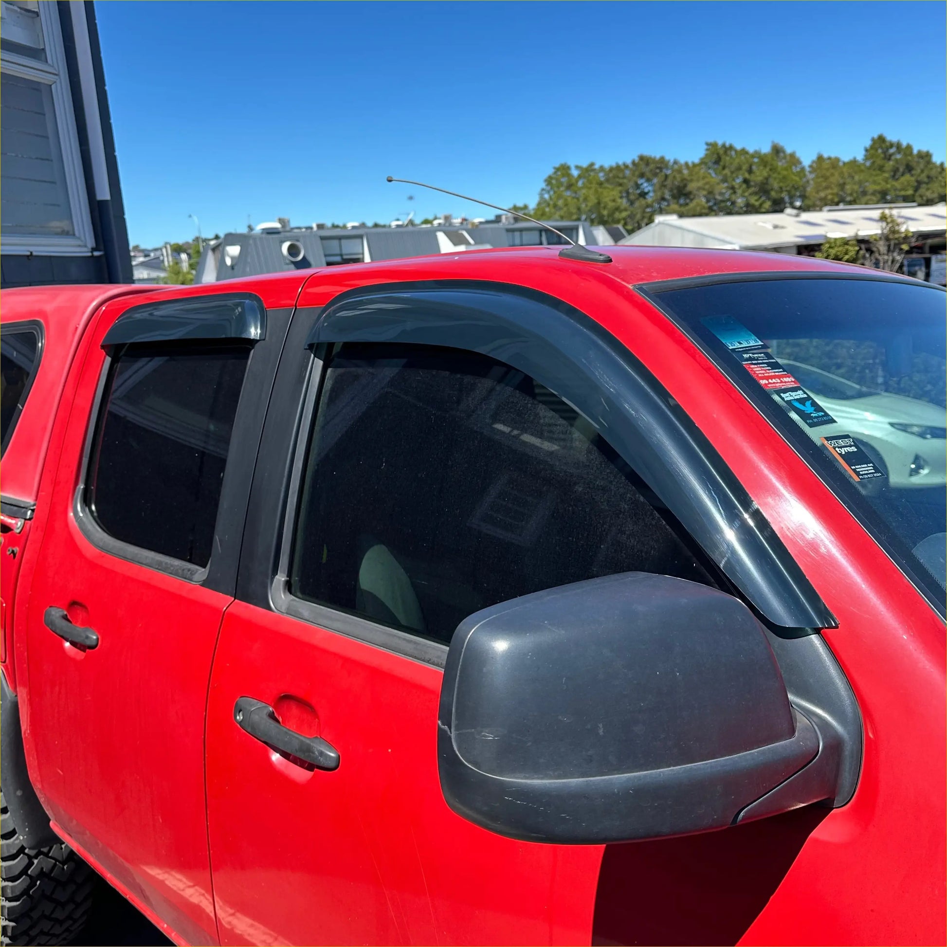 Black plastic window visors installed on red ford ranger pk 2008-2011 with monsoon and bonnet guard