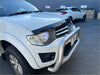 White mitsubishi triton pickup with silver bull bar and chrome grille featuring monsoon and bonnet guard for 2005-2015 models