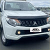White Mitsubishi Triton 2015-2018 pickup with black Monsoon bonnet guard and hood protector on front grille