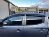 Gray metallic mitsubishi triton pickup with monsoon and bonnet guard featuring black window visors and chrome door handles