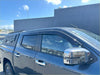 Dark gray metallic mitsubishi triton 2024+ pickup with monsoon bonnet guard and chrome side mirrors black roof rack