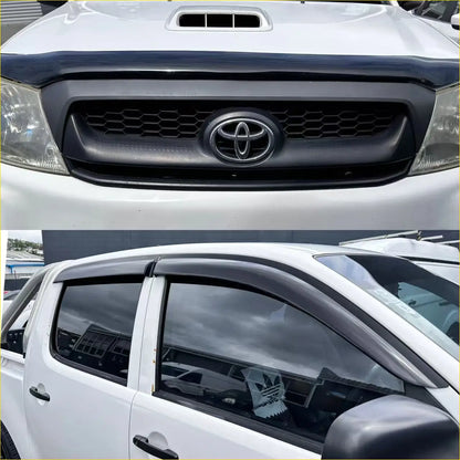 Black plastic front grille with chrome toyota emblem and black window visors on white toyota hilux 2005-2012 pickup