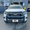 White toyota hilux pickup with black metal monsoon and bonnet guard for 2021-2025 models front view