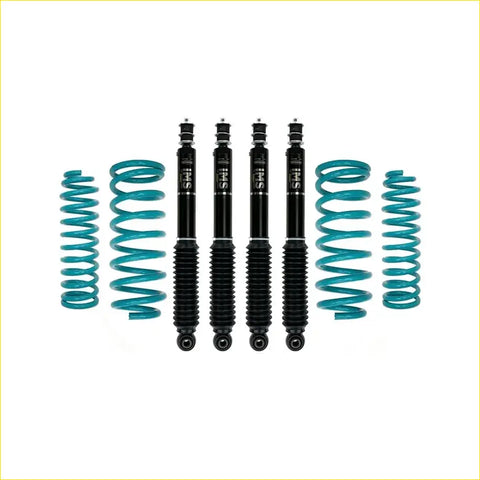 Set of four black sus shock absorbers with teal coil springs for nissan patrol y60 gq wagon 1987-1998 dobinsons ims monotube